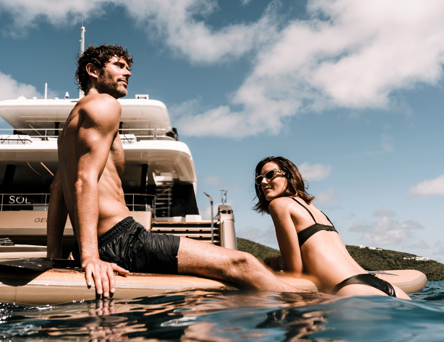 Couple on paddle board during a yacht charter on SOL