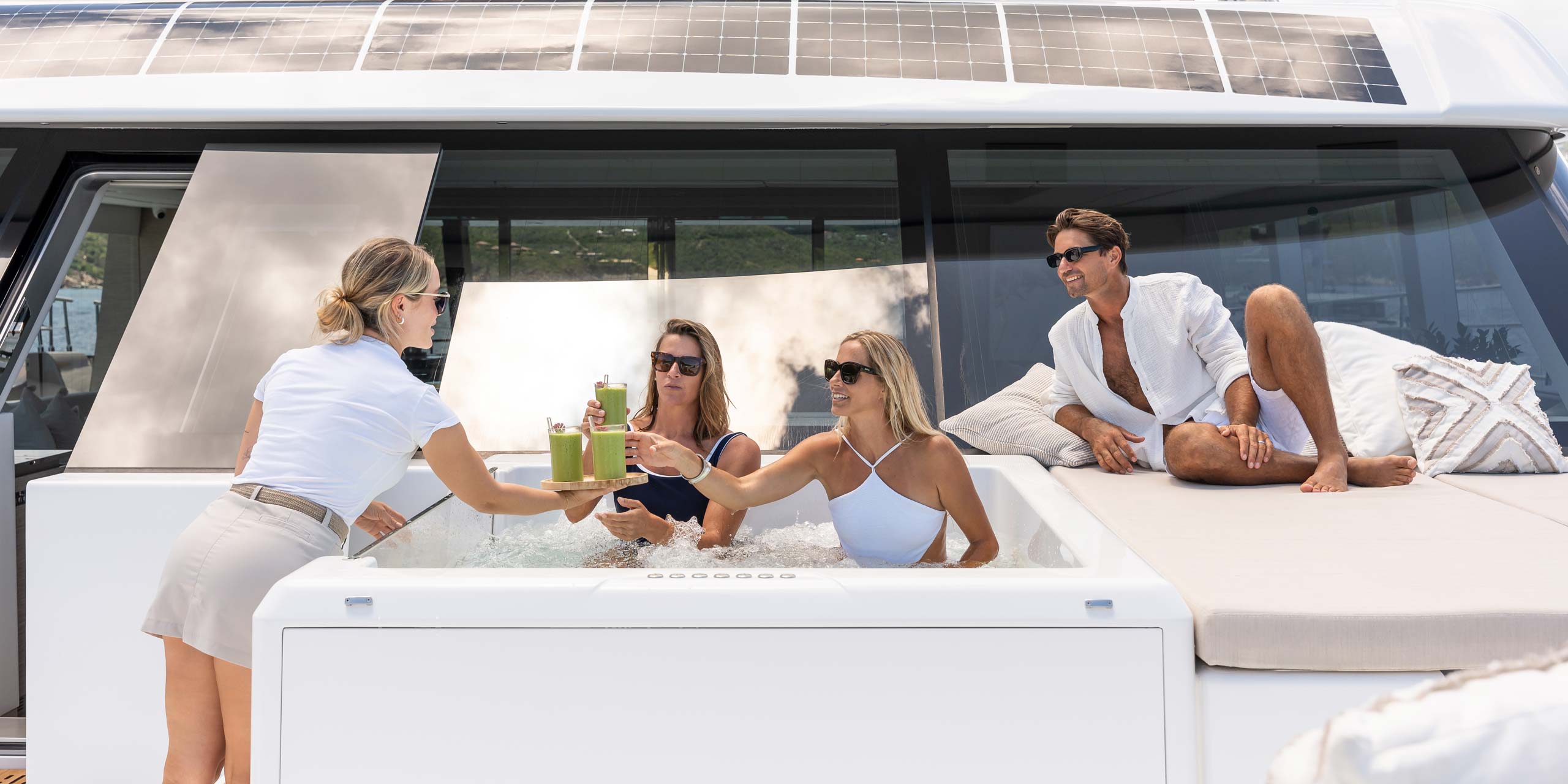 Guests Onboard SOL Yacht Charters enjoying the sundeck lounge are and jacuzzi