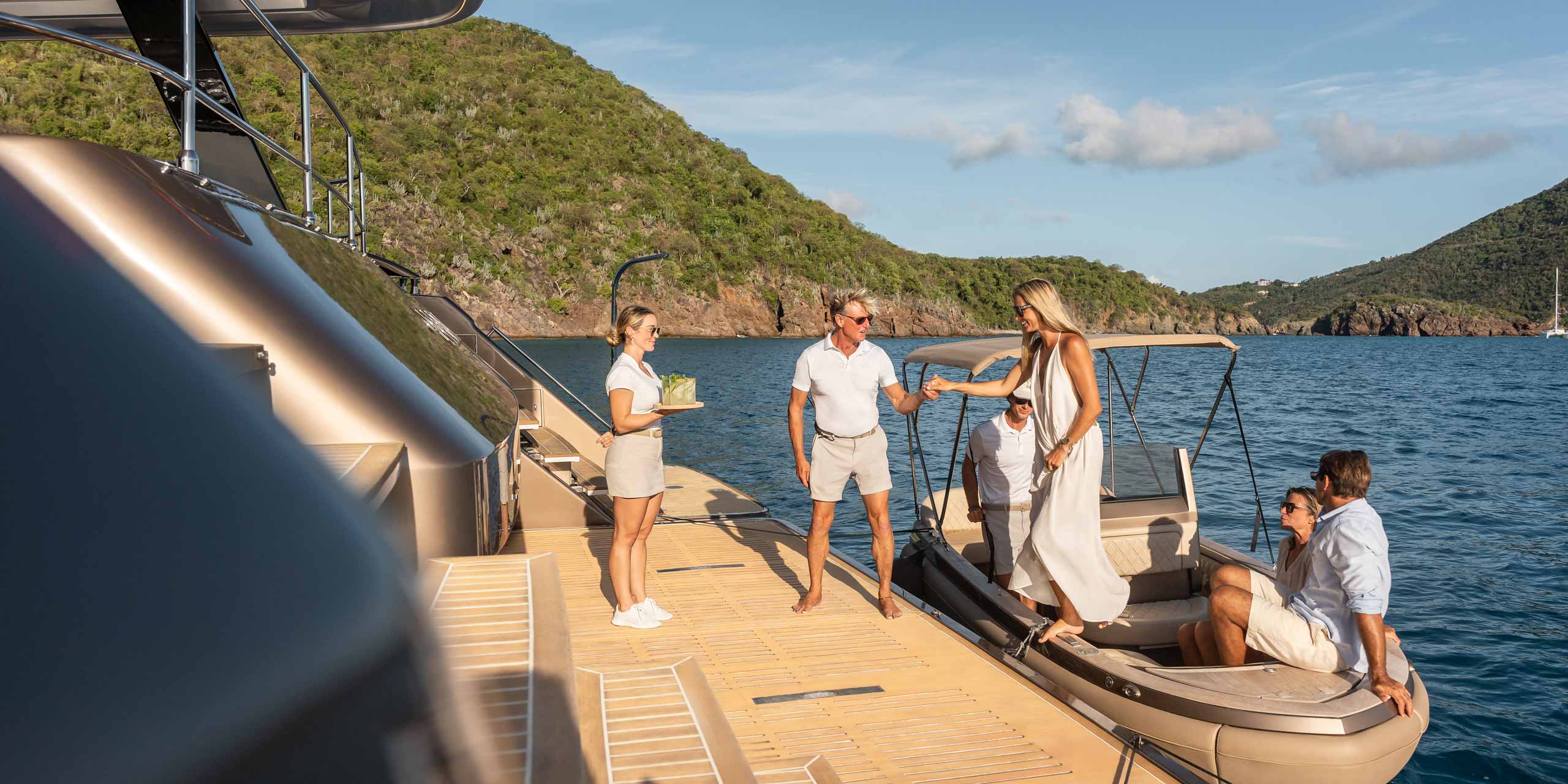 Guests arriving via tender to SOL for a yacht charter