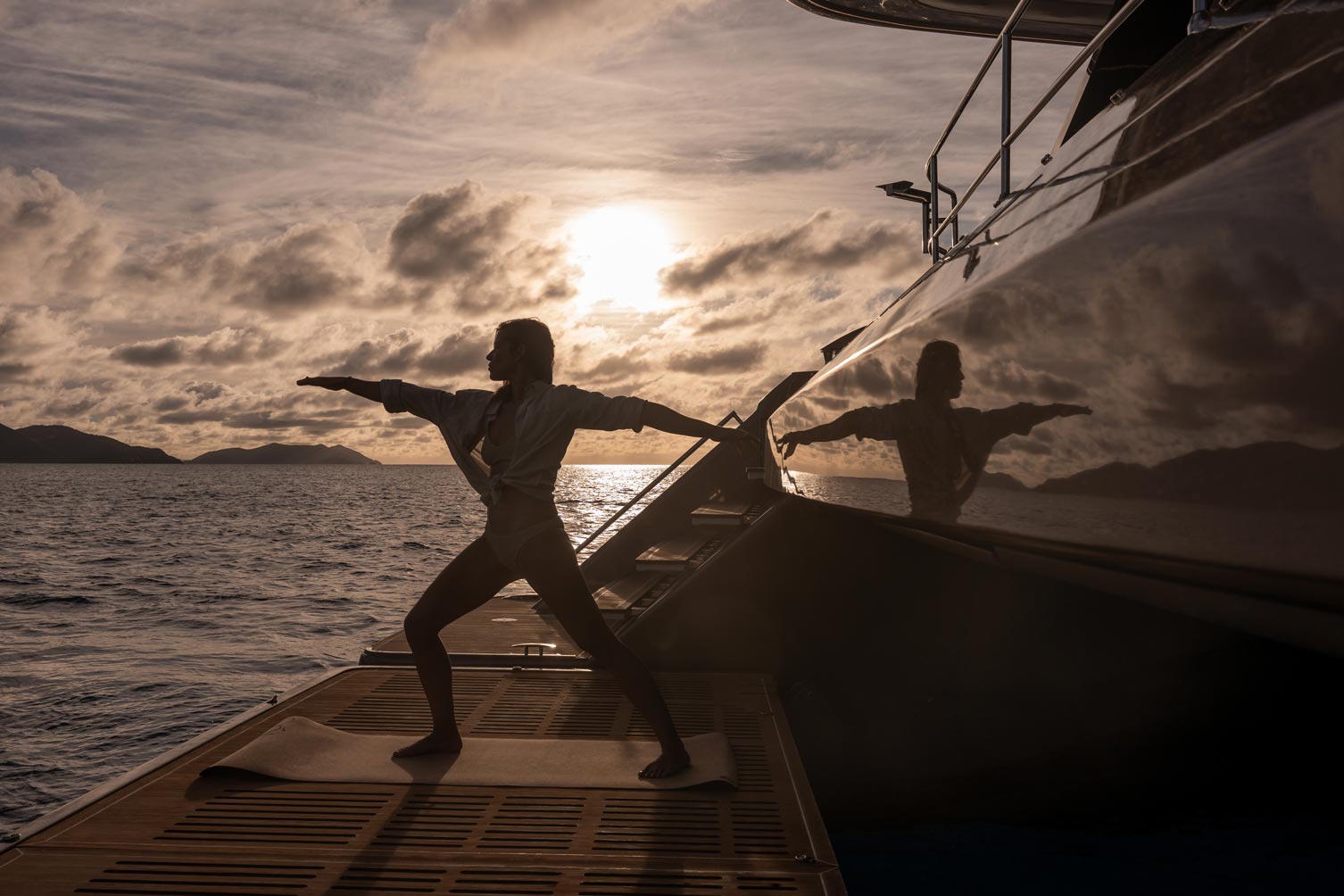 Guest onboard SOL Yacht Charter doing sunrise yoga